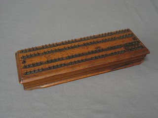 A rectangular "satinwood" and brass cribbage board 11"