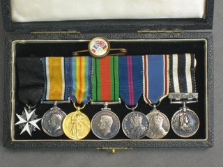 A group of 7 miniature medals comprising  Officer of the Most Venerable Order of St John of Jerusalem, British War medal, Victory medal, Defence medal, George V Coronation medal, George VI Coronation medal, Service medal - St John with bar, together with a Sacred Heart lapel pin and an Allies badge
