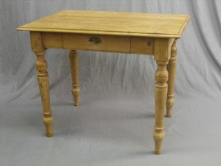 A rectangular Continental stripped and polished pine kitchen table, raised on turned supports 39"