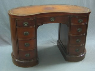A Victorian style mahogany kidney shaped desk with inset leather writing surface above 1 long and 8 short drawers 46"