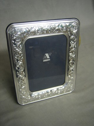 A modern embossed silver easel photograph frame 10" x 7"