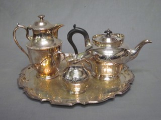 A silver plated teapot with matching cream jug, hotwater jug and an engraved silver plated salver