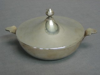 A circular white metal twin handled dish cover, the base marked Pirmans