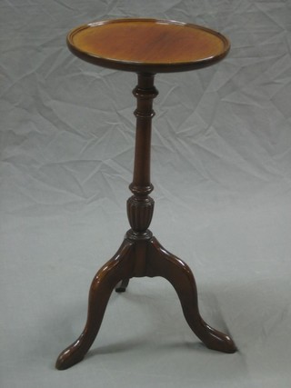 A circular mahogany wine table raised on pillar and tripod supports 11"