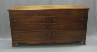 A Georgian style yew sideboard with cross banded top, fitted 2 short and 7 long drawers, raised on splayed bracket feet 60"
