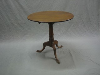 A 19th Century circular oak snap top tea table, raised on a pillar and tripod column 26"