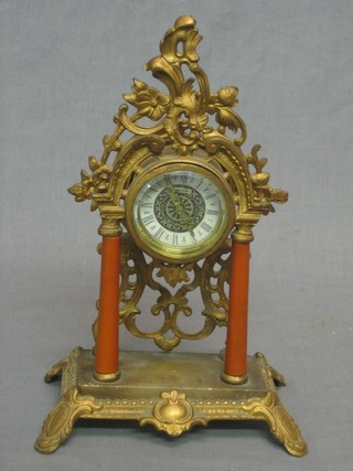 A decorative mantel clock with silvered dial and Arabic numerals, contained in a gilt metal case 8"