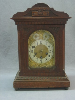 An Edwardian chiming bracket clock with 6 1/2" brass dial, silvered chapter ring, chime/silent indicator and slow/fast indicator, contained in an oak case (some worm, missing hands)