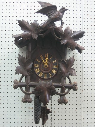 A Continental cuckoo clock contained in a hardwood case