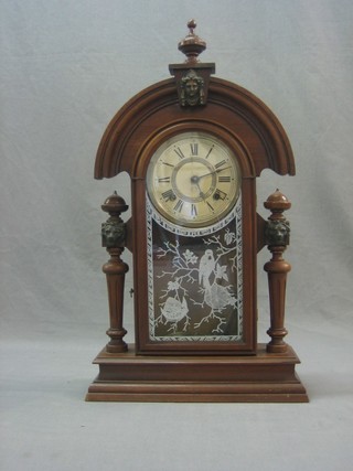 An American 8 day striking shelf clock with paper dial and Arabic numerals by Ansonia, contained in a walnut case and enclosed by a glazed panelled door