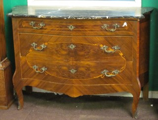 A French Kingwood commode of serpentine outline and black veined marble top, fitted 3 long drawers and raised on cabriole supports (some old worm) 50"