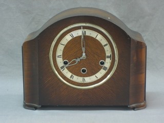 A 1930's chiming mantel clock contained in an oak arch shaped case with chrome bezel (f)