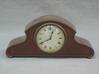 A 1930's 8 day bedroom timepiece with silvered dial and Roman numerals contained in an inlaid mahogany arch shaped case