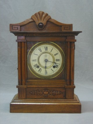 A Japanese 8 day striking mantel clock with painted dial and Roman numerals contained in an oak case by Kosha