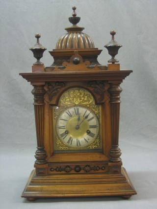 A 19th Century Continental 8 day striking bracket clock with 6 1/2" brass dial, silvered chapter ring and Roman numerals contained in a domed walnut case with finial decoration