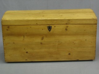 A Continental stripped and polished pine dome shaped trunk with hinged lid and iron drop handles 37"