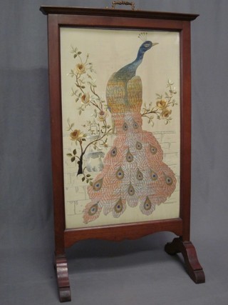 An Edwardian embroidered fire screen decorated a bird contained within a mahogany frame 24"