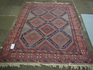 A blue and red ground "Belouch" carpet with 8 diamonds to the centre 79" x 54"