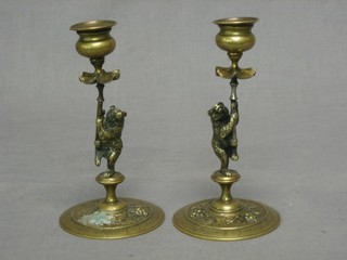 A pair of Victorian brass candlesticks supported by figures of bears 6"