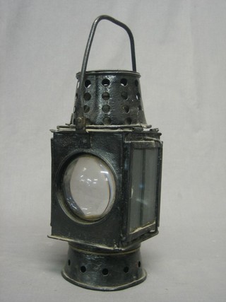 A Bullseye lantern contained in a black metal case