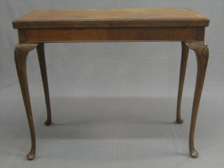 A 1930's Queen Anne style rectangular walnut card table with crossbanded top, raised on cabriole supports 36"