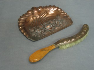An Art Nouveau embossed brass crumb scoop complete with brush 9"