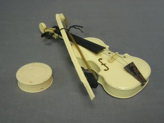 A white plastic Airfix model of a violin and bow 10" together with a circular French white plastic rouge pot