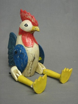 A wooden articulated figure of a cockerel 9"