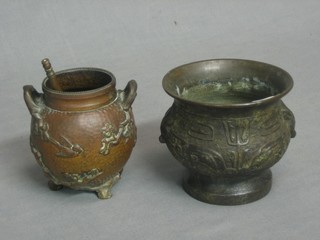 An Eastern bronze bowl with cast decoration, the base with seal mark 4", a twin handled bronze urn decorated birds amidst branches 4" and 1 other bronze cylindrical item
