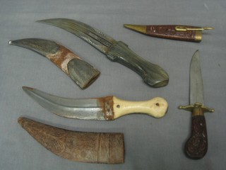 An Eastern dagger with 7" blade, 1 other and an Indian knife with carved hardwood scabbard