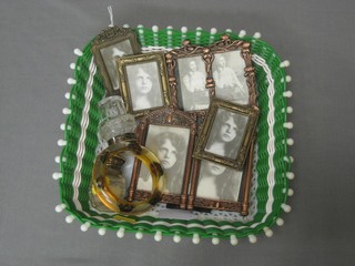 A plastic bangle decorated insects, 2 glass condiment bottles and 5 various decorative photograph frames