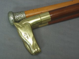 A walking stick, 2 walking sticks with brass handles and a walking cane with silver handle