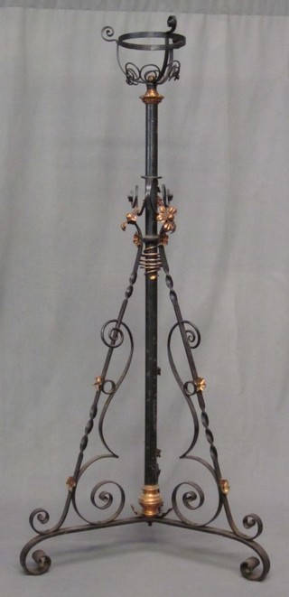 A Victorian wrought iron adjustable oil lamp stand
