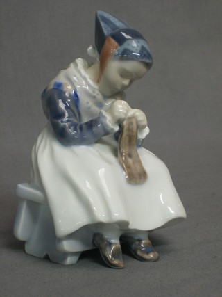 A Royal Copenhagen porcelain figure of a seated girl knitting, the base marked 1314 5"