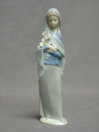 A Lladro figure of a lady with bunch of lilies 9"