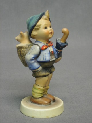 A Hummel figure of a standing boy with umbrella and pannier with pig 4"