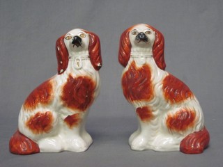 A pair of 19th Century Staffordshire figures of seated Spaniels 7 1/2" (some cracks)