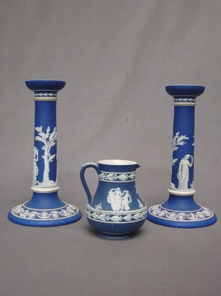 A pair of Wedgwood blue Jasperware candlesticks, the base impressed Wedgwood 9" (1 chipped) and a Wedgwood blue Jasperware jug 5"