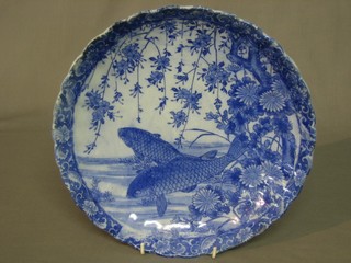 An Oriental blue and white plate decorated diving carp and with scalloped border 11"