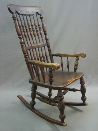 A 19th Century elm stick and bar back kitchen rocking chair