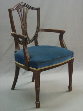 A Georgian mahogany shield shaped open arm carver chair with shield shaped back and upholstered seat, raised on square tapering supports ending in spade feet