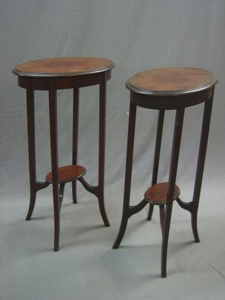 A pair of Edwardian oval mahogany 2 tier occasional tables raised on tapered supports 17"