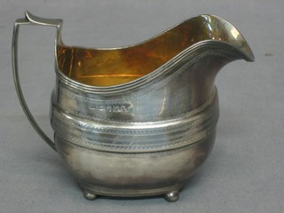 A Georgian silver cream jug, raised on 3 bun feet, London 1807 4 ozs