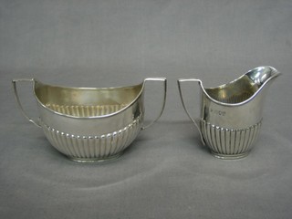A Victorian oval silver twin handled sugar bowl and cream  jug, London 1894 10ozs