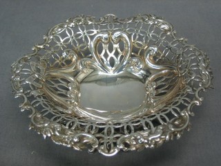 A Victorian circular pierced silver bon bon dish raised on panelled supports, London 1892, 3ozs