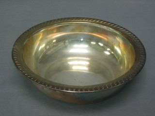 An American circular white metal bowl with gadrooned border, base marked English silver MFG Corp