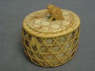 An oval Japanese carved ivory trinket box in the form of a monkey cage, the finial decorated a monkey, the base signed 3"
