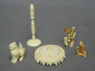 A carved ivory puzzle ball base (f), a carved ivory figure of a temple dog 1" and 2 other carved ivory figures