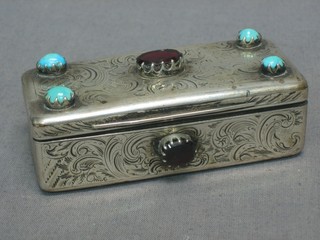 An Eastern silver box, the hinged lid set red stones and turquoise, marked 34, 3"