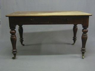 A  Victorian bleached mahogany writing table, fitted 2 frieze drawers and raised on turned supports 51" 
